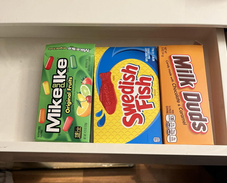 Boxes of three different kinds of candy in a desk drawer